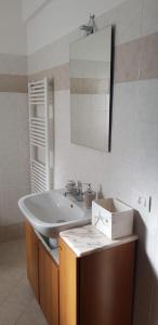 a bathroom with a sink and a mirror at La casa del Re in Sipicciano