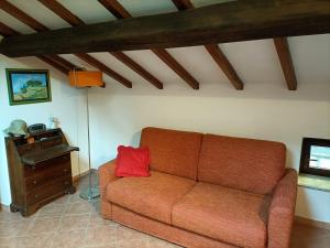 a living room with a couch and a table at La mansarda del Sacro Bosco in Bomarzo +11 photos