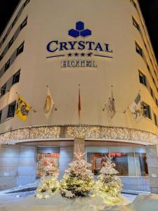 a hotel building with christmas trees in front of it at Crystal Hotel superior in St. Moritz