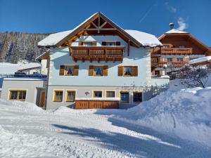 a large building with snow on the ground at Hansalagut in Mauterndorf