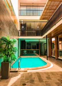 a swimming pool in the middle of a building at FH Hotel in Iquitos