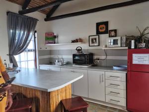 a kitchen with a counter and a red refrigerator at Agulhas Heights in Agulhas