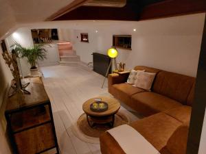 a living room with a couch and a table at Het Waterhotel in Heerenveen