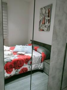 a mirror in a bedroom with a bed with red roses at Bella Vigevano in Vigevano