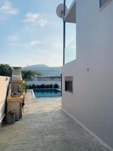 a house with a patio with a swimming pool at Astra House in Porto Rafti