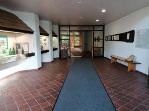 a hallway of a building with a bench and a table at Haus Schwarzwaldgrund in Baiersbronn