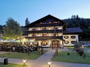a large building with people sitting outside of it at Brandeberg Pension & Restaurant in Bran