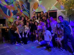 a group of people posing for a picture at a party at Lacandona Hostel in Córdoba