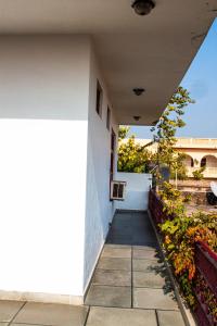 a white building with a balcony at Falcon guest house in Bharatpur