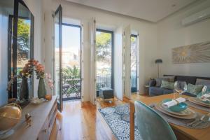 a living room with a table and a couch at THE TWIN Apartments in Porto
