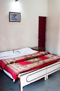 a bedroom with a large bed in a room at Falcon guest house in Bharatpur