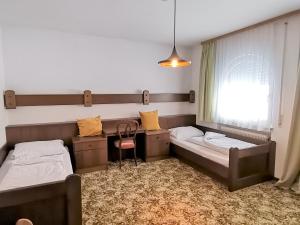 En eller flere senge i et værelse på Rafael Kaiser Residence Privée - Spielberg Obdach