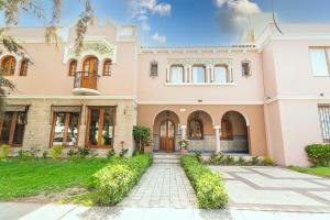 a large house with a walkway in front of it at Hotel Arequipa Vive in Arequipa