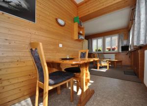 a dining room with a wooden table and chairs at Chalet Ideal Saas-Fee in Saas-Fee