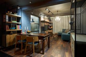 a dining room and living room with a table and chairs at Premium Luxury SeaSide Apartment in Burgas City