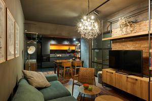 a living room with a couch and a television at Premium Luxury SeaSide Apartment in Burgas City