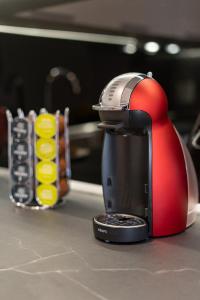 a red coffee maker sitting on a kitchen counter at Petit Palace Trikala in Tríkala