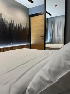 a bedroom with a large bed and a large window at MM Kolasin Lux N1 in Kolašin