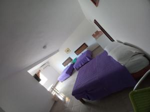 an overhead view of a bedroom with a purple bed at Airport Sleepy Inn in Cancún