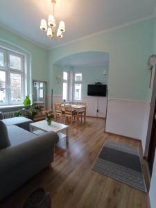 a living room with a couch and a table at Fiore in Duszniki Zdrój