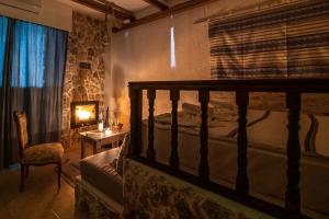 a bedroom with a bed and a table and a chair at Limeri Traditional Guest House in Monólithos