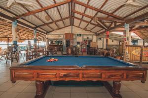 a pool table in the middle of a building at The Barrel Hostel in Popoyo