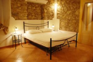 a bedroom with a bed and a table with a lamp at incantevole e storico appartamento in pieno centro in Taormina