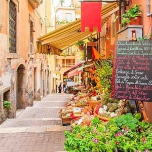a street with a vegetable market in a city at incantevole e storico appartamento in pieno centro in Taormina