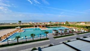 una vista sul tetto di una piscina con ombrelloni e palme di Deluxe Resort and SPA a Shkodër