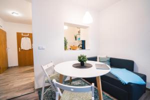 a small living room with a table and a couch at Ferienwohnung Maria - Gera Zentrum NEU renoviert in Gera +17 photos