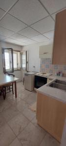 a large kitchen with a table and a sink at Casa Maria in Cardedu