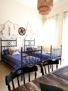 a bed room with two beds and a desk at Appartamento Porto Marina in Licata