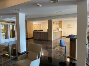 a lobby with a chair and a counter in a building at Apartman DreamHome in Vrnjačka Banja