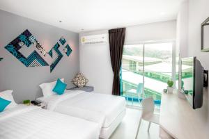 Ένα ή περισσότερα κρεβάτια σε δωμάτιο στο The Crib Patong - SHA Certified