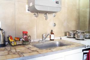 a kitchen counter with a sink and a mixer at A una cuadra de la playa con vista in San Clemente del Tuyú