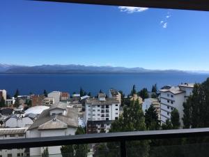 a view of a city and a body of water at Maqui Departamentos in San Carlos de Bariloche