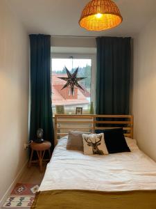 a bedroom with a bed and a window with a star at mieszkanko_karkonoska in Jelenia Góra