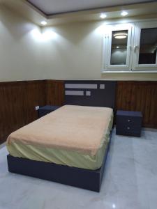 a bedroom with a bed with two tables and a microwave at Appartamento vicino alle piramidi in Cairo