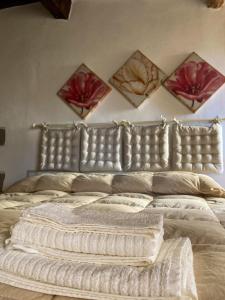 un grande letto con testiera in pelle in una camera da letto di Agorà a Montecatini Val di Cecina
