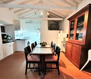 een keuken en eetkamer met een tafel en stoelen bij Casa do Arcanjo in São Roque do Pico