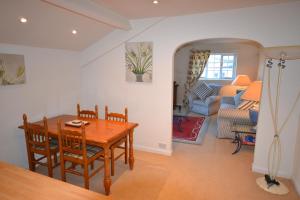 a dining room with a table and a couch at Eagle Cottage in Penrith