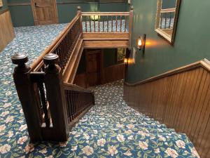 a staircase in a building with a stair case at Grand Central Hotel in Eureka Springs