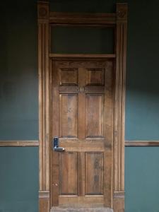 a wooden door with a handle on it at Grand Central Hotel in Eureka Springs