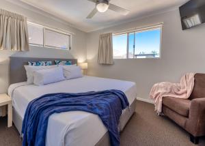 un dormitorio con una cama y una silla en Noosa Sun - On the Noosa River, en Noosaville 62 fotos más