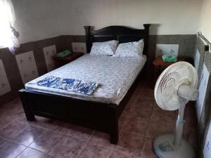 a bedroom with a bed with a fan at PLAYA ARCO IRIS in Cabo de la Vela