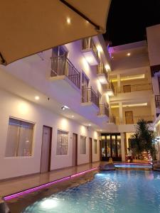 a house with a swimming pool at night at VICTORIA INN in Paniki