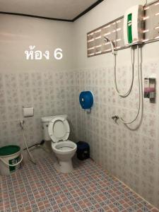 a bathroom with a toilet and a shower at Pimpa House in Ban Hua Nam Mae Sakut
