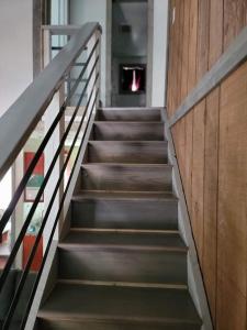 a staircase in a house with wood and metal railing at Greer Point Trails End Cabins in Greer