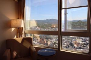 a room with a view of a city from a window at Rhine Inn in Keelung