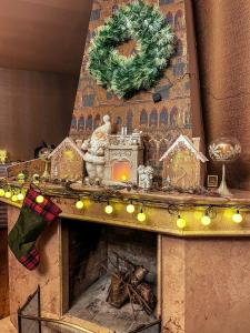 a fireplace with christmas decorations on top of it at BFG Suites Leselidze in Tbilisi City